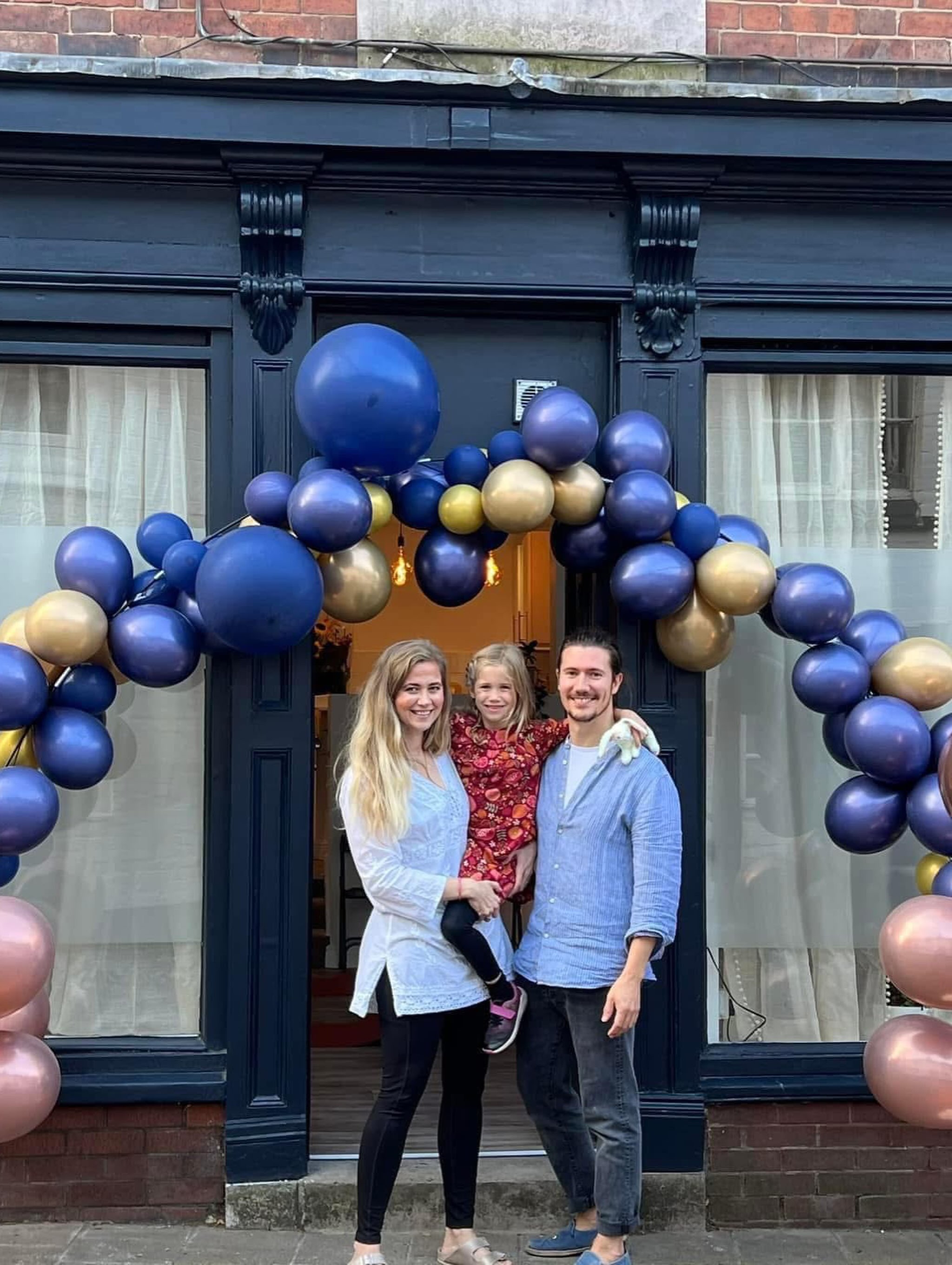 The navy studio shopfront on Queen Street with a balloon arch on opening day
