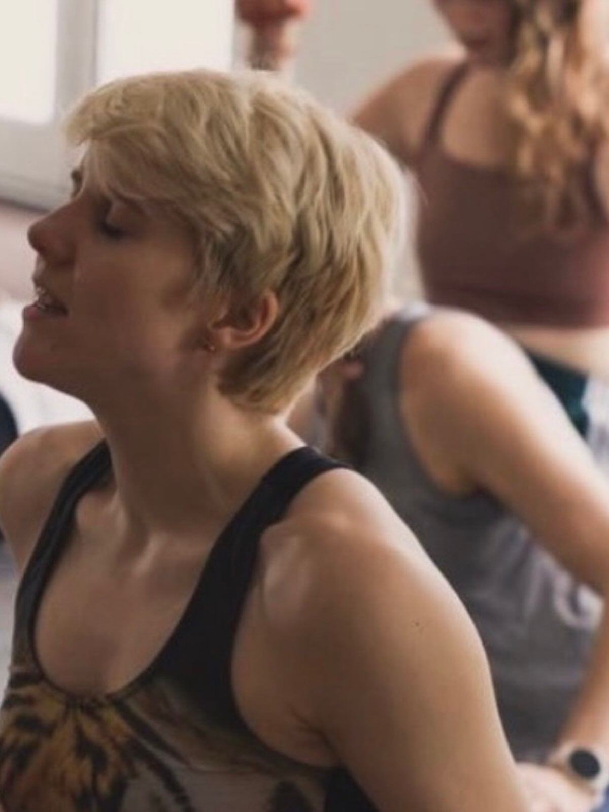 A student with eyes closed, mid practice